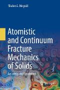 Atomistic and Continuum Fracture Mechanics of Solids: An Integrated Treatment
